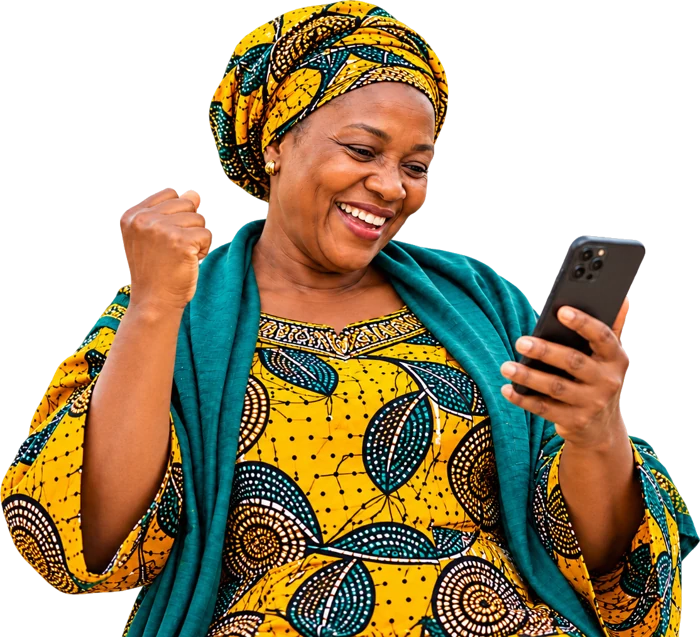 A woman smiling at good news on her phone